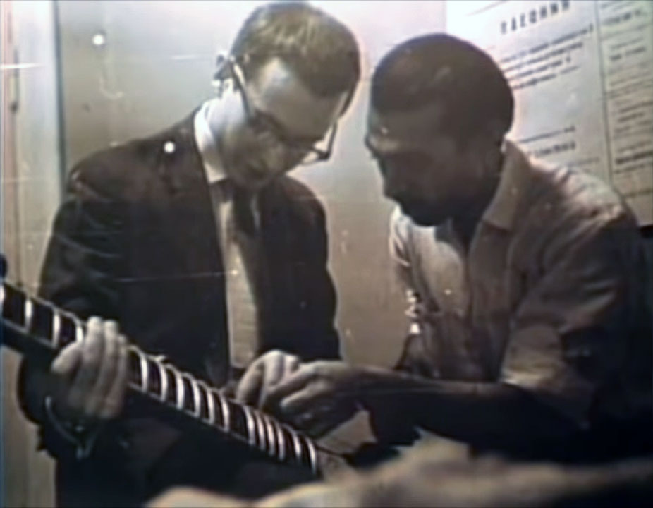 Yuri Bezmenov learning an Indian musical instrument